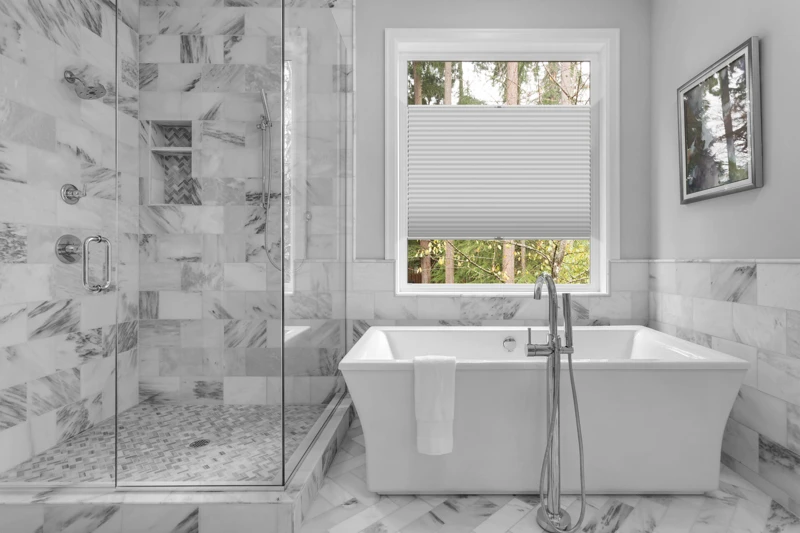 Bathroom with bathtub and shower in new luxury home with all gla