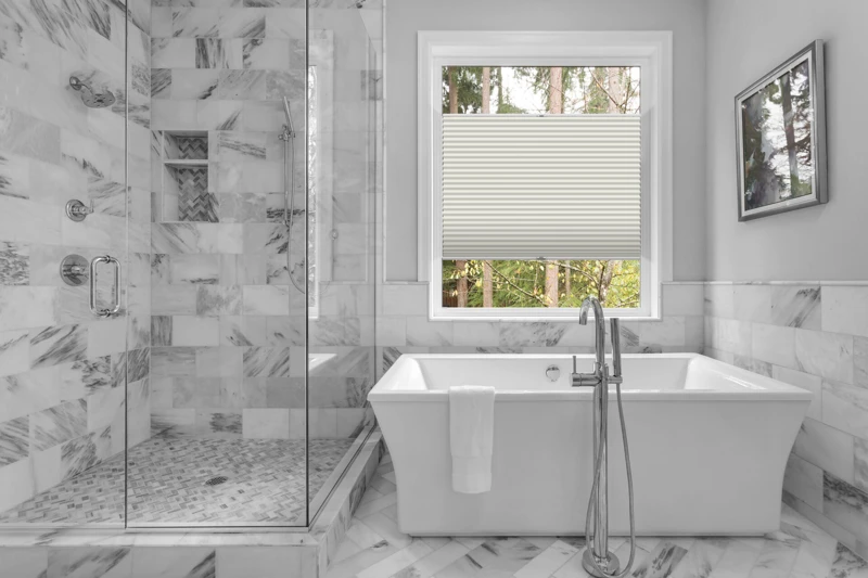 Bathroom with bathtub and shower in new luxury home with all gla