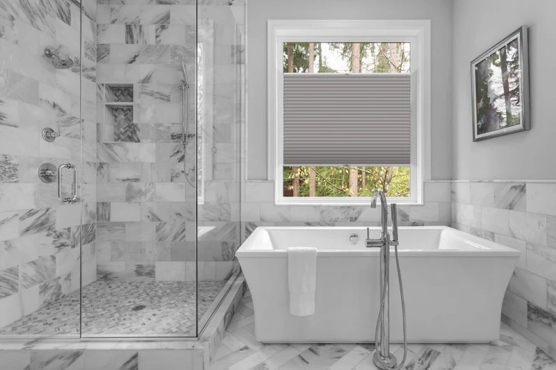 Bathroom with bathtub and shower in new luxury home with all gla